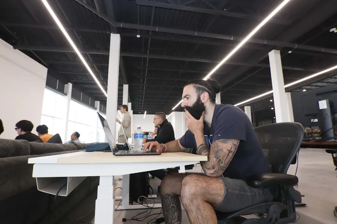 A participant working at a laptop alongside others in Randmar’s coworking space