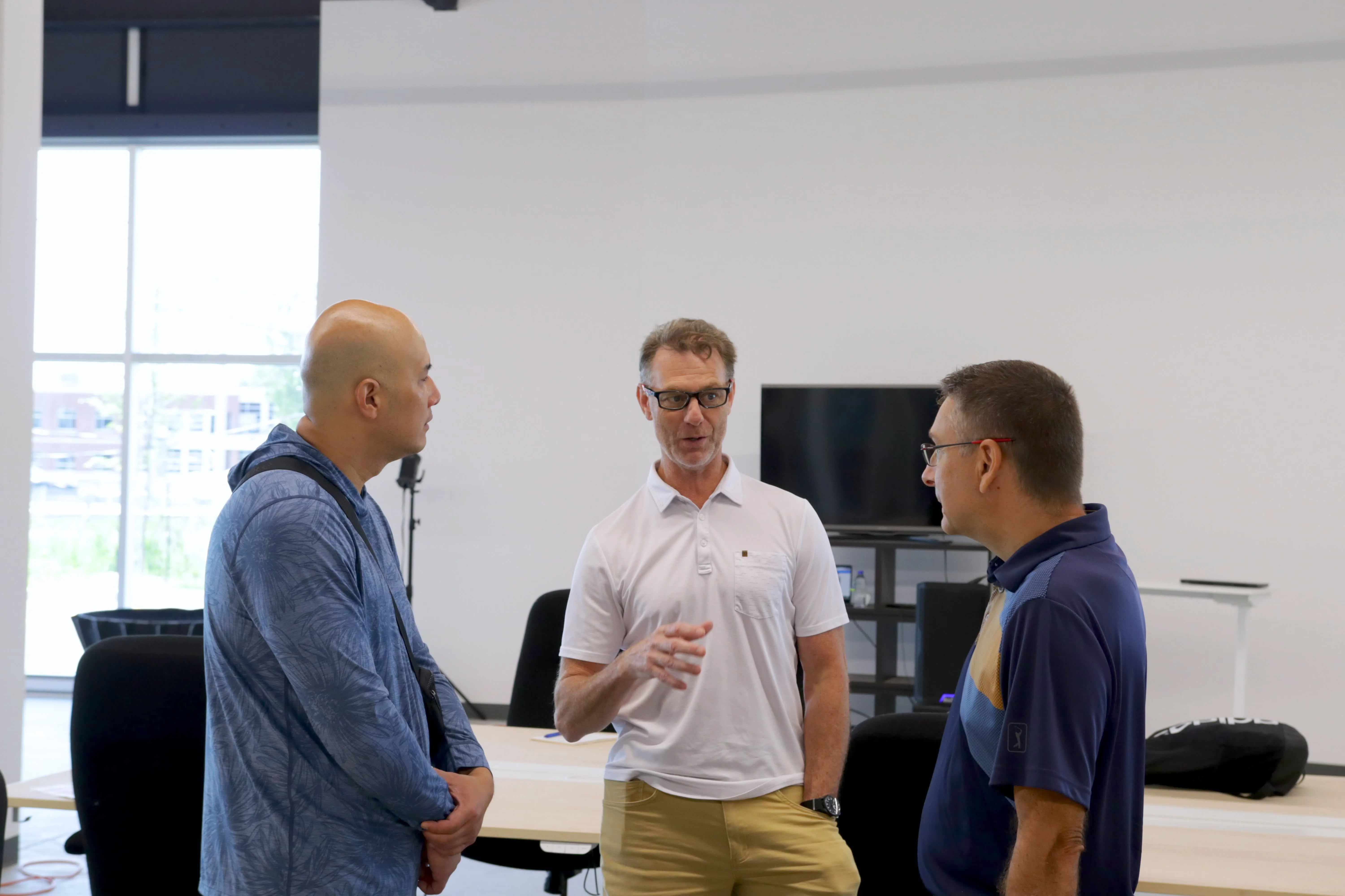 Three attendees in conversation at a Randmar event