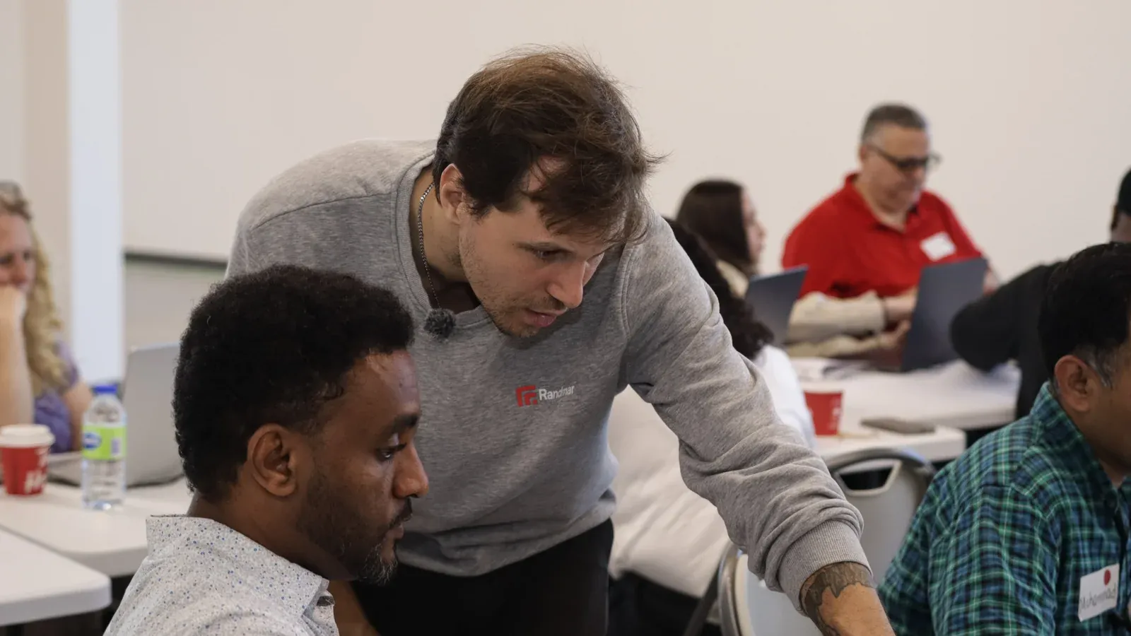 Gislain Armand helping a participant during a tutoring session