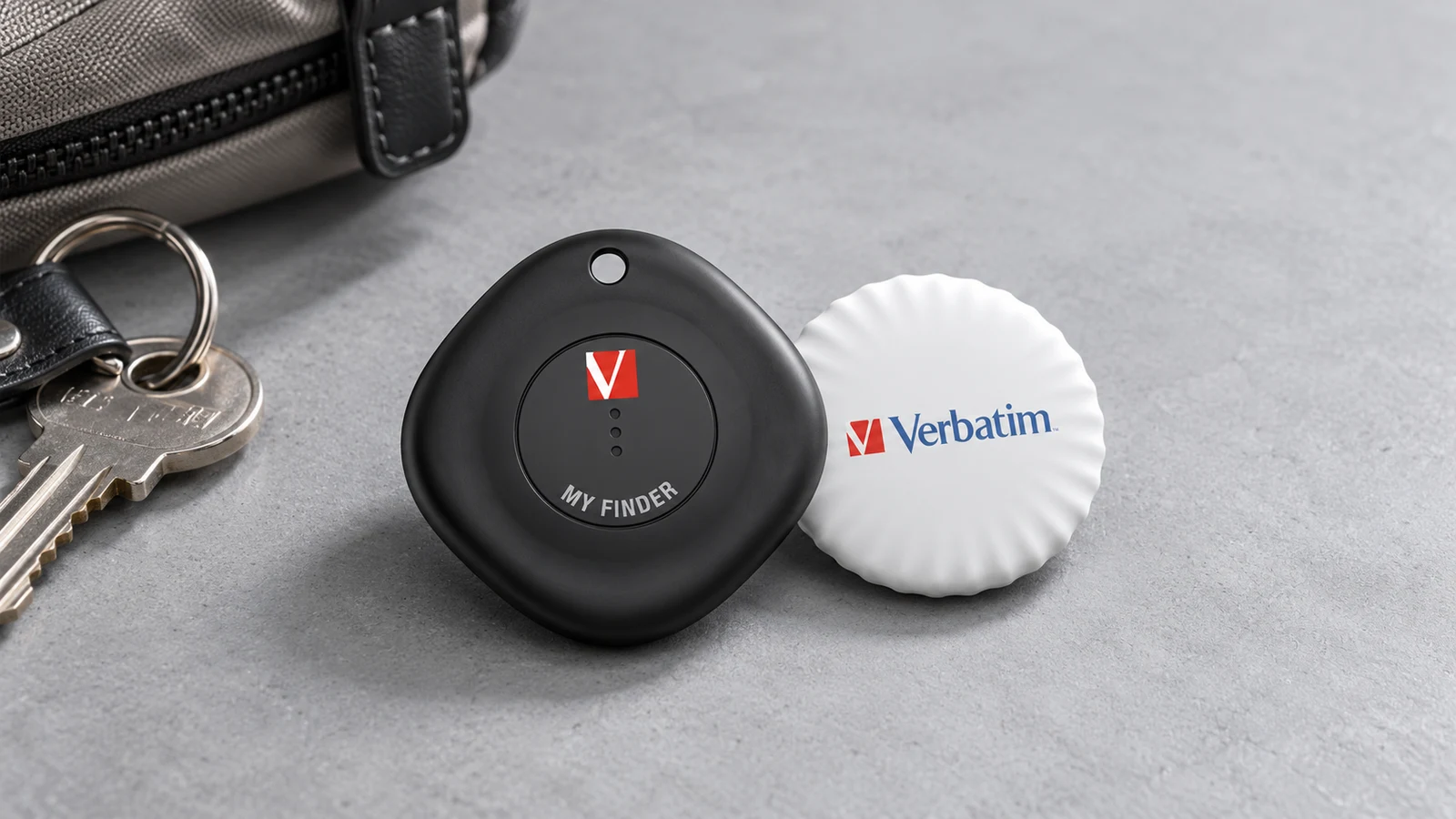 Editorial product photograph of a black Verbatim My Finder tracker and white compact coin, generated from manufacturer-supplied product references