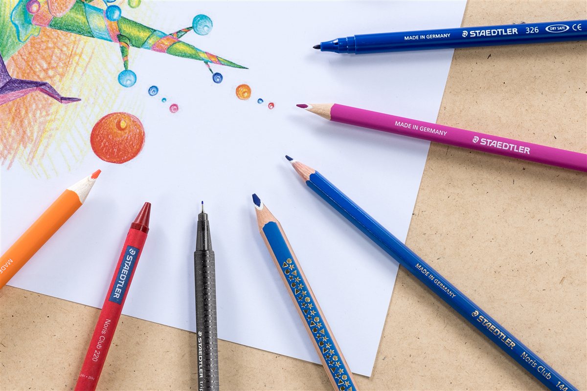 STAEDTLER coloured pencils and drawing tools around a colourful sketch
