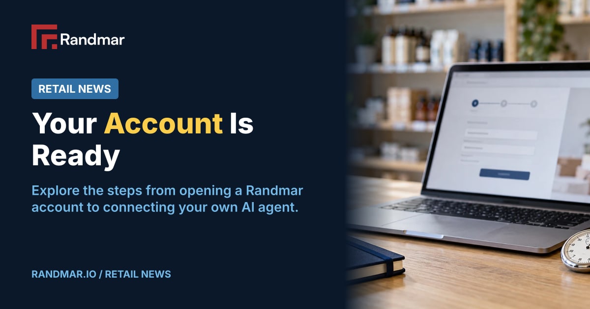 Your Account Is Ready; Illustrative editorial photograph of a laptop and stopwatch beside a navy notebook and plain sample carton in a retail back office.